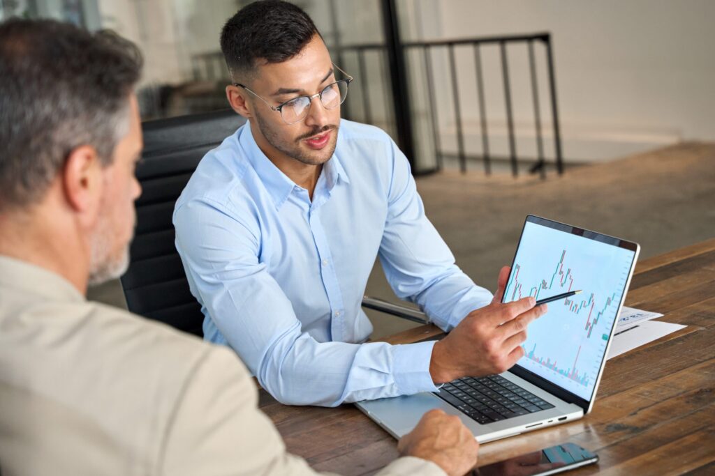 A business consultant presenting to a client in a professional meeting.