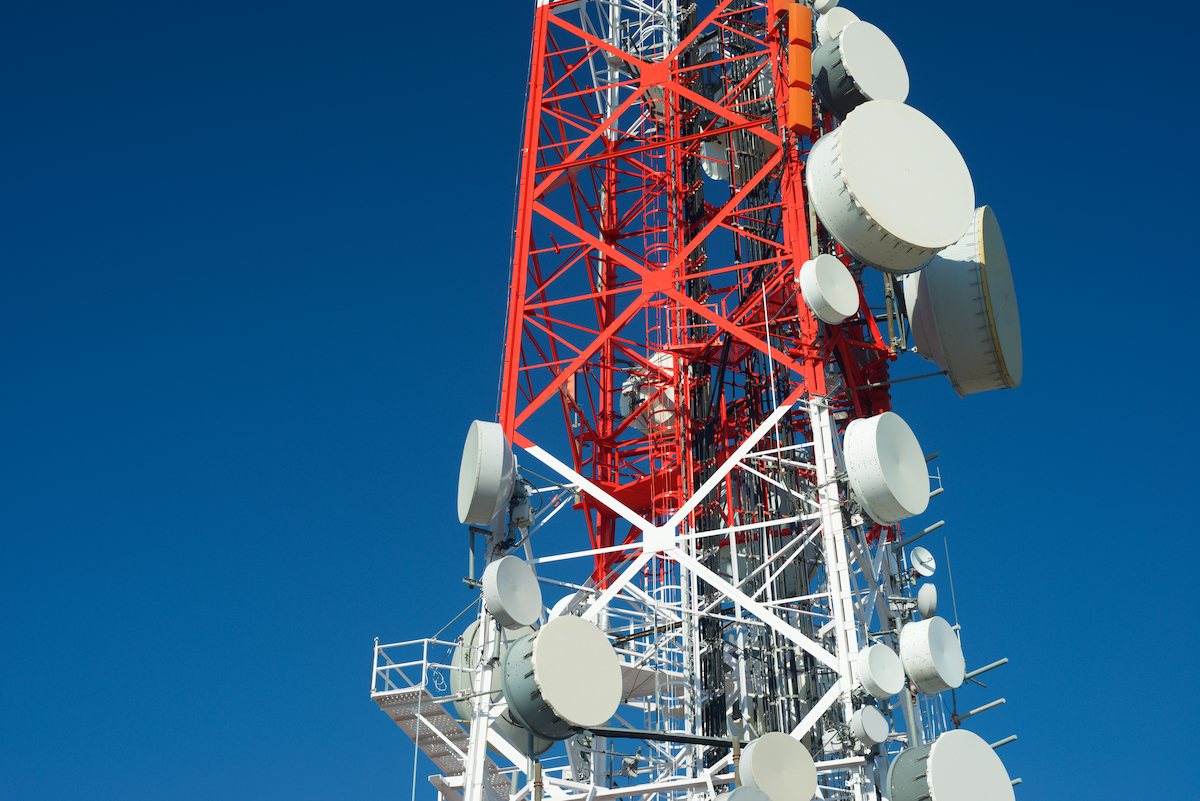 A tall cell tower against a clear blue sky